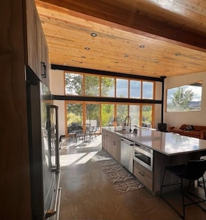 View of kitchen, dining, great room and sliding glass doors