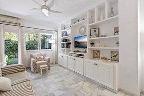 Pleasant and bright living room with sofa bed and armchair to enjoy a moment of relaxation.