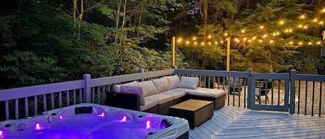 **Back Deck**

Take a deep in the soothing 5+ person hot tub built into the back deck. Turn on the hot tub lights, jets, link to the built-in bluetooth speakers and enjoy the surrounding peaceful scenery.
