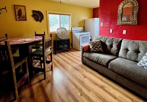 Pull out full-size sofa bed and dining table share a room
