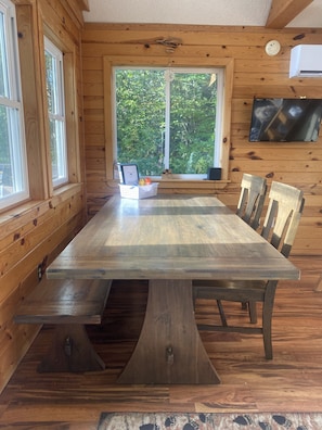 The indoor dining table includes a bench, 2 chairs, and 2 stools