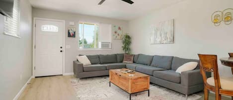 Large, stylish and comfortable sectional couch and 70' wall mounted tv. This space opens up to the dining area, to allow all guests to sit and entertain together.