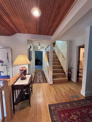 Hallway to bedrooms and bathroom, stairs to loft