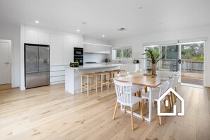 Spacious open plan living area which opens to the north and south facing decks