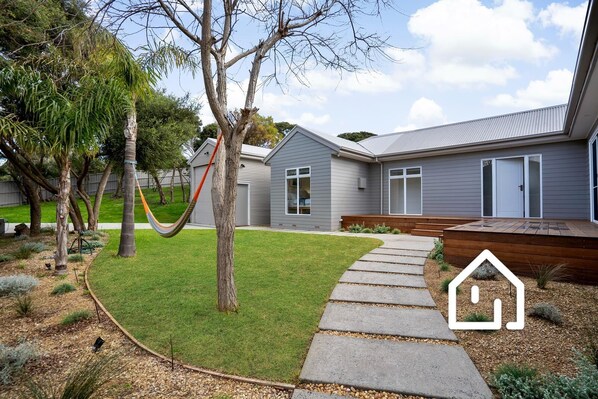 Entry via the pedestrian gate and path to the house and south facing deck