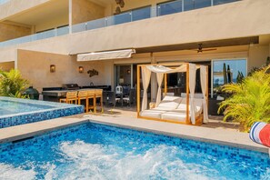 Poolside view of patio and canopy bed