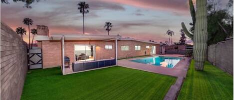 Backyard with pool, comfortable outdoor seating, and grill (pool is not heated)