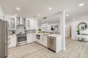 Spacious kitchen with modern appliances and a gas stove.