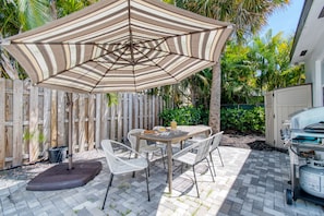 Outdoor table and BBQ/grill for al fresco meals.