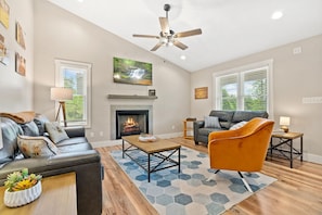 Spacious living area with plenty of seating, high ceilings, gas FP, Roku TV