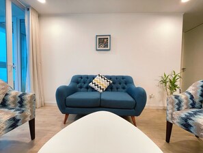 Living room with a blue sofa.