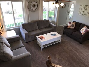 Livingroom view from stairs. Livingroom has seating for seven.