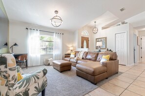 Open and bright living area with updated light fixtures