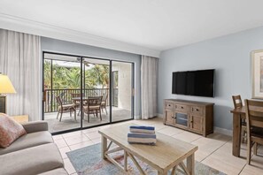 Large living room overlooking tropical gardens and pool area