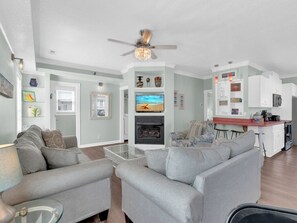 Living room with queen sleeper sofa, smart TV, cable, and half bath.