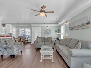 Living room with queen sleeper sofa, smart TV, cable, and half bath.