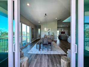 "Savor the art of dining al fresco without leaving the comfort of home. Our dining room seamlessly spills into an enchanting screened-in porch, where every meal becomes a breath of fresh air. "