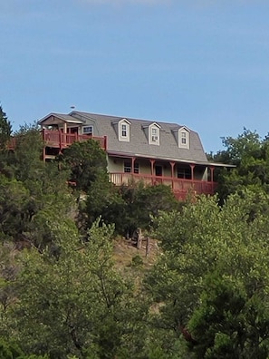 View of hilltop home from road entire home for short or long term rent secluded