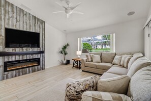 Relax In The Living Room On The Large Sectional with Fire Place and TV