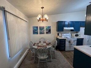 Dining room table and fully stocked kitchen with coffee maker and pots pans etc.