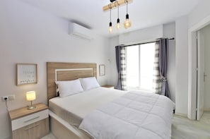 Master bedroom with king size bed and air conditioning