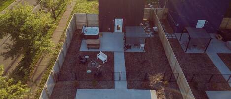 Backyard vibes ft. hot tub, picnic table, grill, campfire area with seating