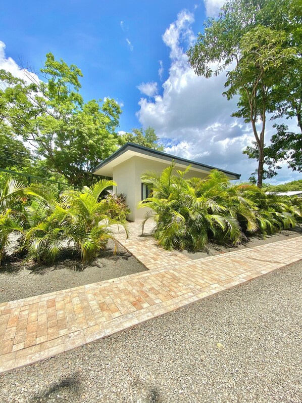 Lobos One Casita surrounded by greenery. Image taken from driveway.