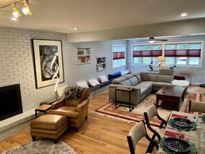 The ground floor living room has lots of seating  and modern decor