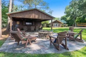 Large covered patio with TV, dart board, mini fridge & grill. Awesome fire pit!