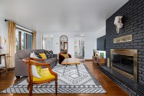 Living room. Kitchen and bedroom in background.