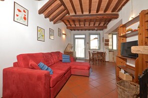 The living room with dinner area and kitchen corner