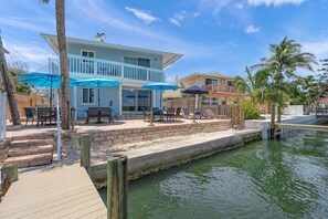 Watch boats glide by and birds drift overhead from this inviting shared patio, just around the corner from your door.