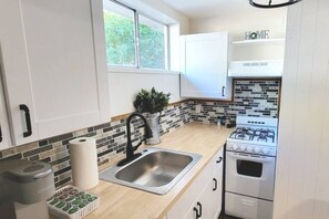 Brand new kitchenette! Tile backsplash and butcher block countertops!