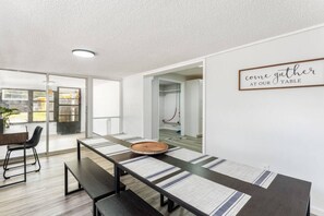 Bright space with a dining table, desk, and garden view
