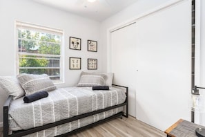 room with trundle bed and tv