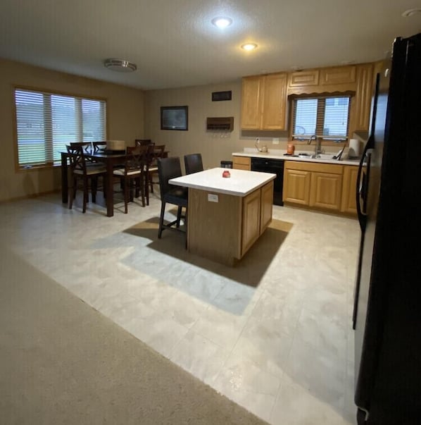 Open kitchen/dining area looking out the windows at the golf course.