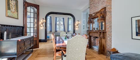 Large Dining room with ornate wood floors and fireplace, lots of seating options