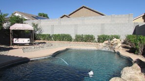 Backyard pool, waterfall and porch swing