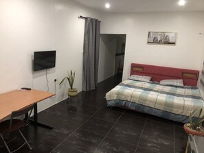 Spacious bedroom  with a workspace and a kitchenette 