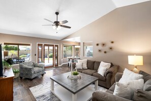 Wall of windows opens up to the backyard in this open floor plan.  