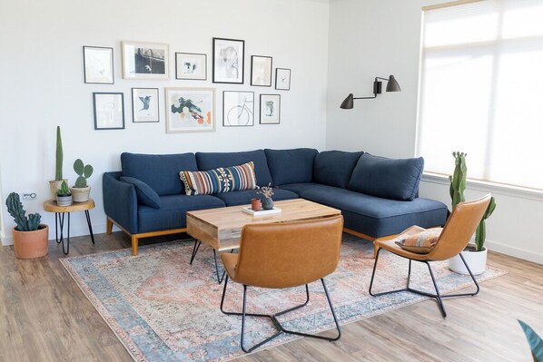 Bright, boho-chic living room with cozy textures and balcony access.