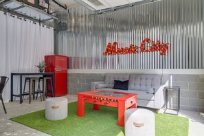 Full Size Ping Pong Table, Table Foosball, Plenty of Lounging and Seating Along with Nostalgic Fridge in Garage Gameroom