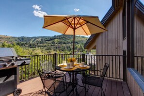 Large Private Deck off Kitchen with BBQ grill, breathtaking Resort Views, and outdoor table and chairs