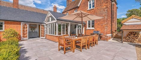 Patio area with outdoor dining table & BBQ