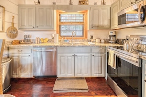 The kitchen is well stocked with pots/pans, utensils and small appliances. T