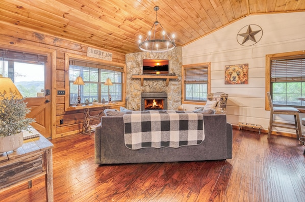 A cozy living room with infinity game table and Roku TV,
