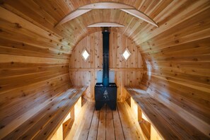 Barrel sauna is 7 feet tall in the middle and can sit 6+ with a separate changing room.