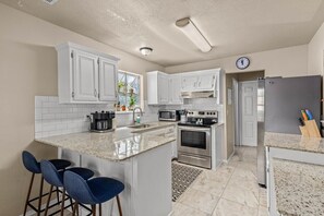 Elevate your culinary space with the timeless elegance of white cabinetry. 