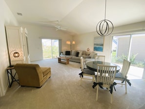 Sunlight filled living room with 2 sliding doors