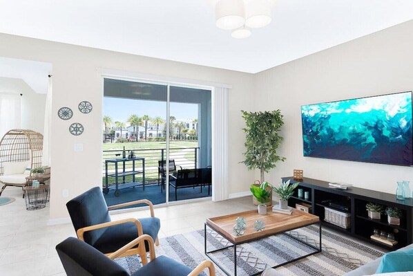 Living Room with 70" Smart TV and Pool View!#Disney #Parks #kingdom #springs #StoreyLake #Apartment #Vacation #Rental #waterpark #Kissimmee #Orlando #universal #citywalk